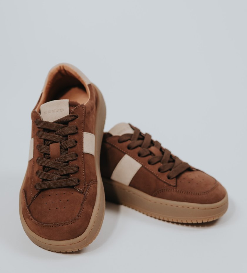 A pair of BREJD Bosund in cognac, seen from above against a light background.